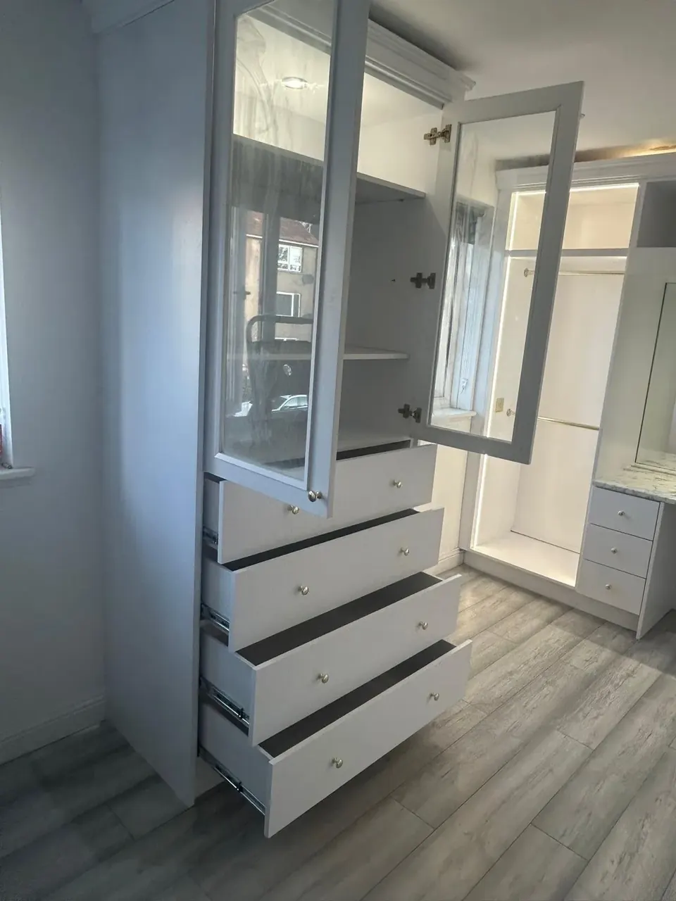Glass-fronted cabinetry and drawers photographed open after fitting